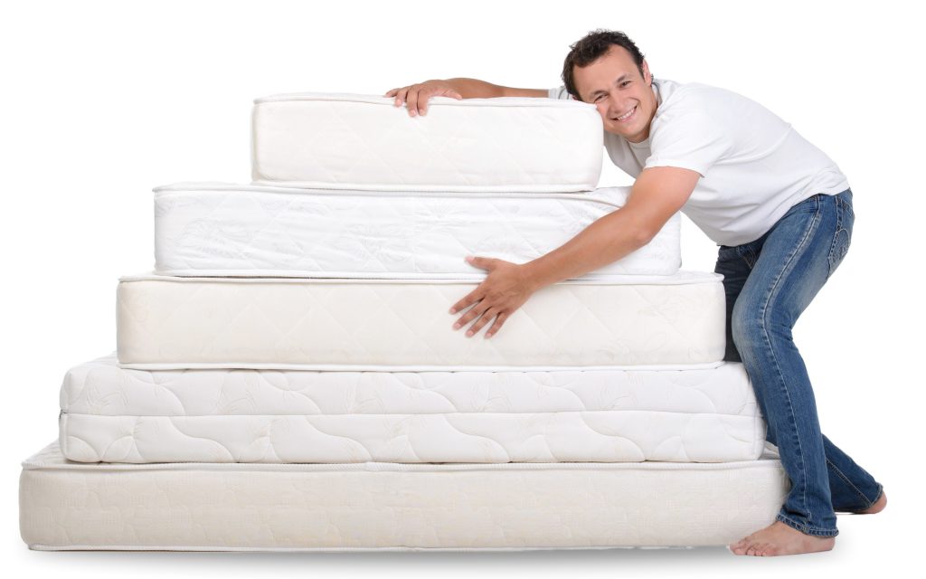 funny-man-pajamas-sitting-lots-mattresses-scaled